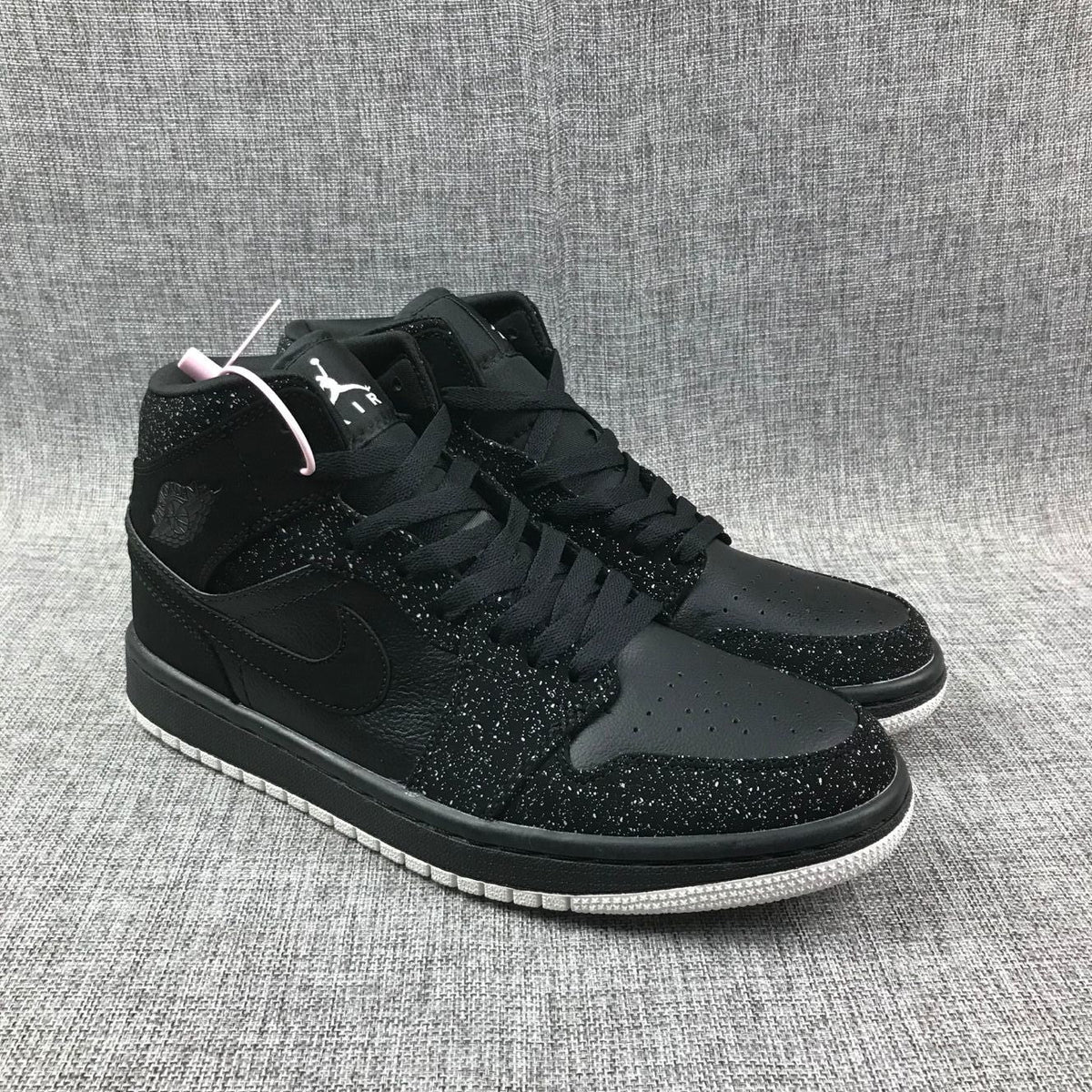 Air Jordan 1 Mid Black and White Sneakers 554724-001 - product image from the listing.