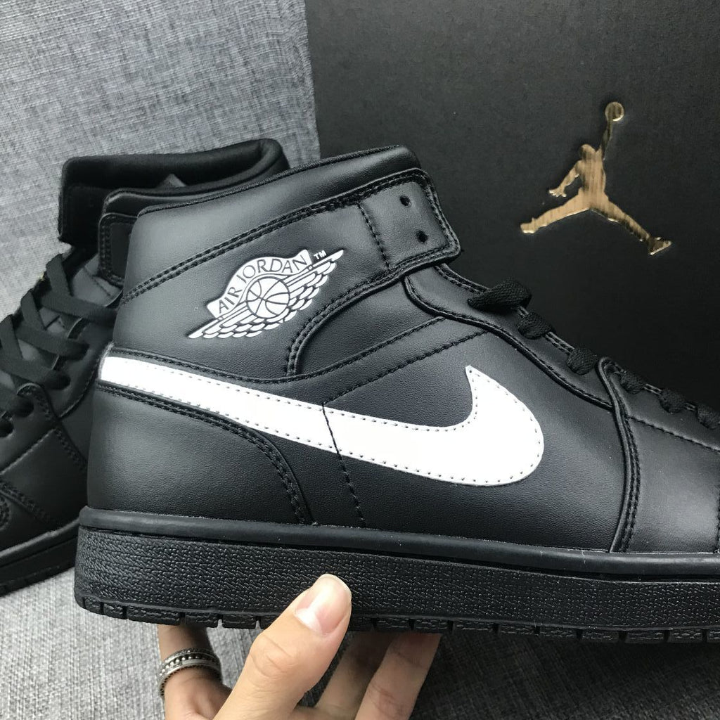 Air Jordan 1 Mid Sneakers in Black White 554724-049 - product image from the listing.