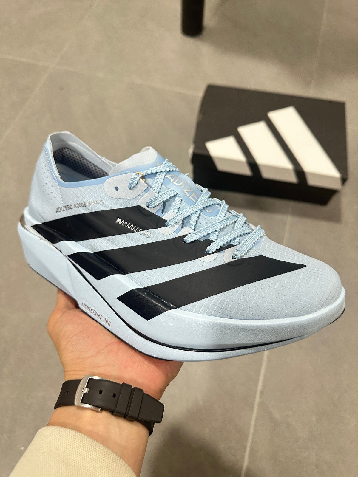 adidas Adizero Adios Pro Running Shoes, in Light Blue and Black - product image from the listing.