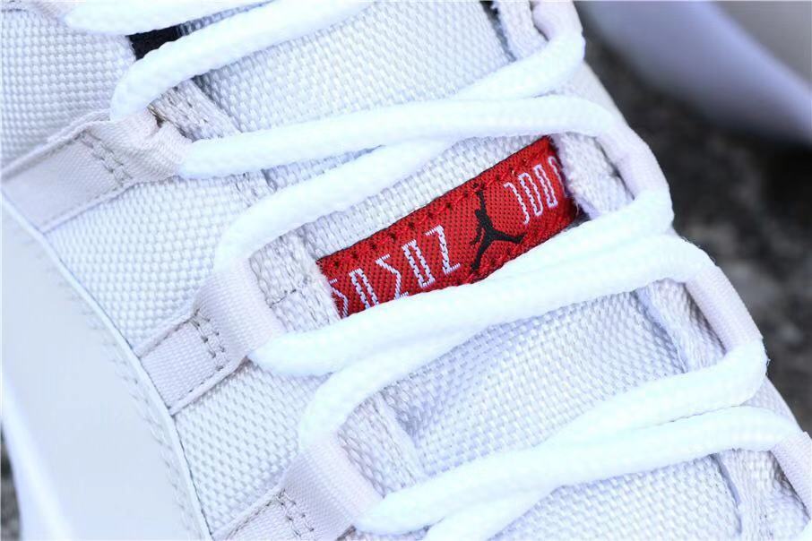 Air Jordan 11 Platinum Tint White High-Top Sneakers - product image from the listing.