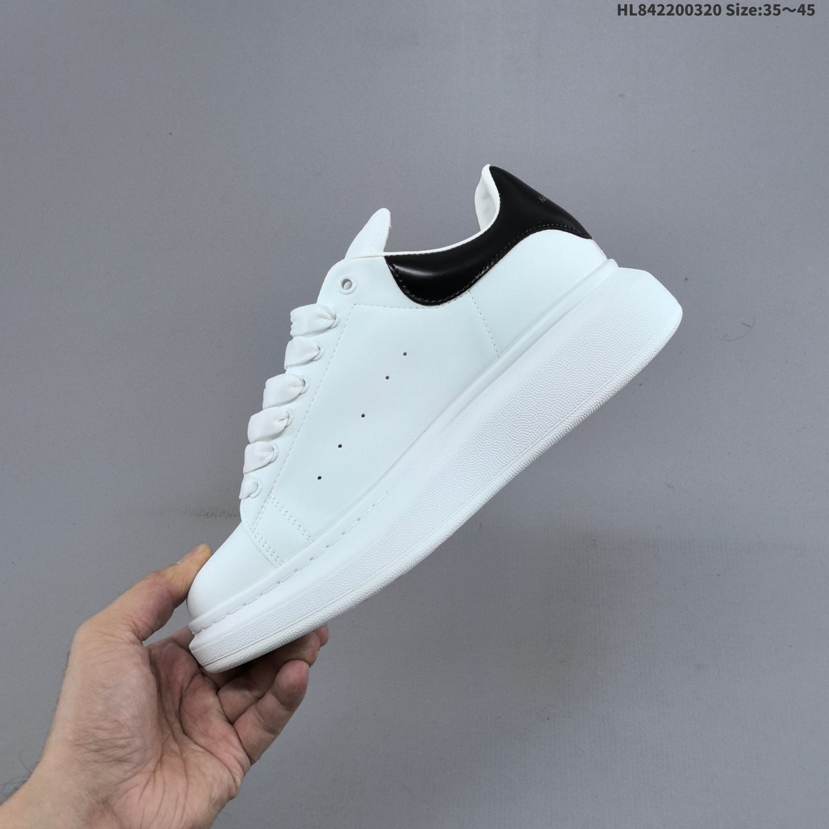 Alexander McQueen Oversized Low-Top Sneakers, in White and Black - product image from the listing.