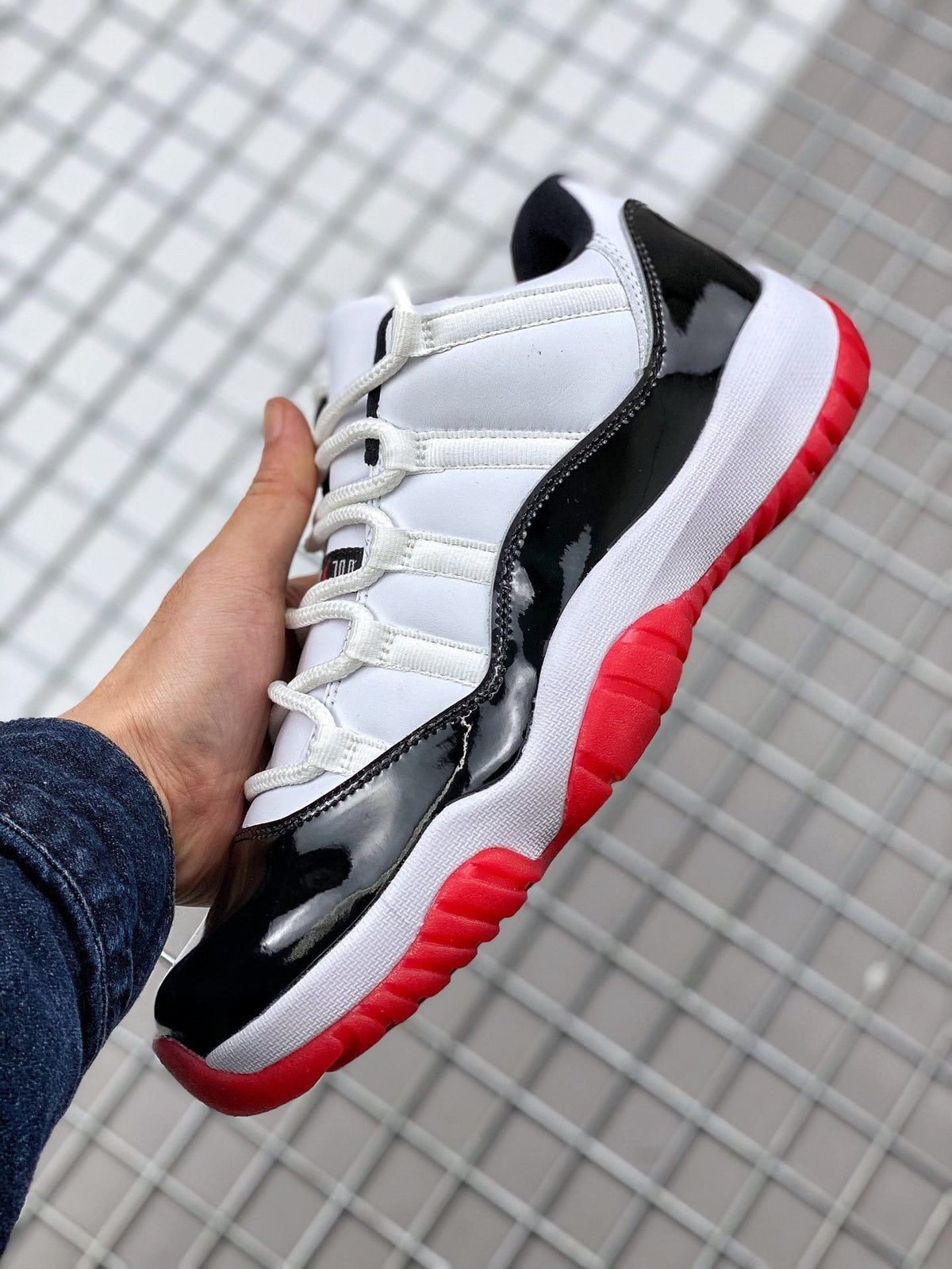 Air Jordan 11 Win Like '82 Sneakers in White Black Red - product image from the listing.