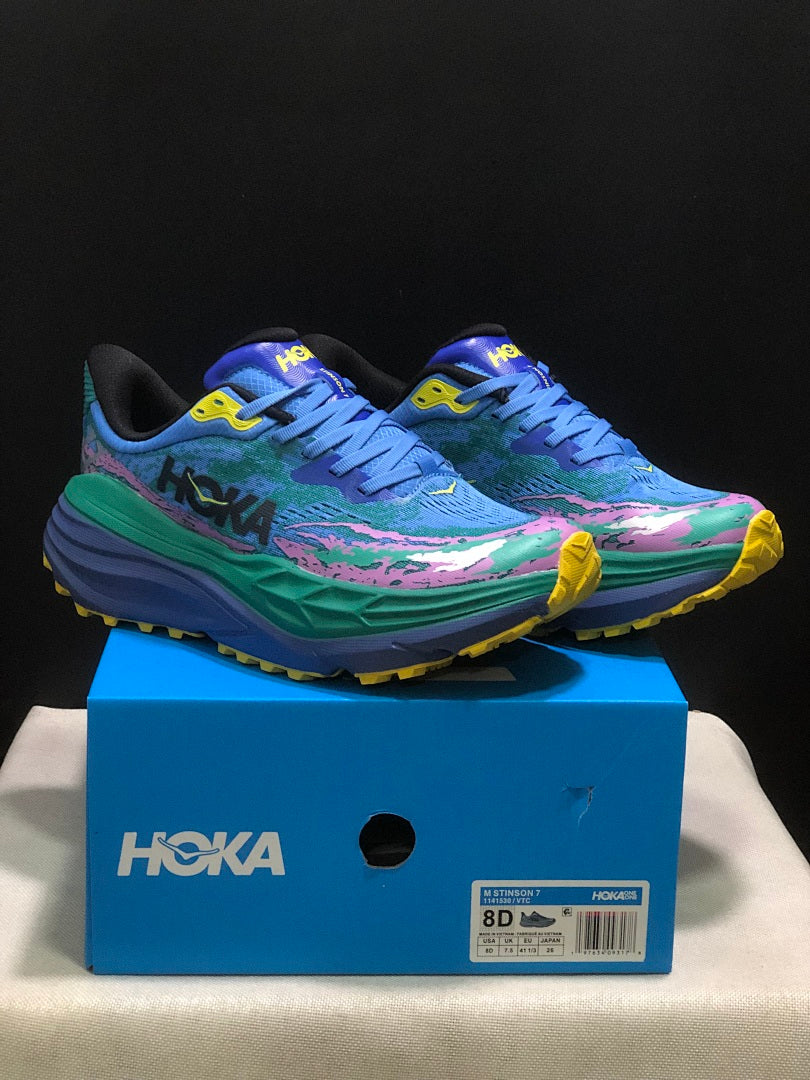 HOKA Stinson 7 Trail Sneakers in Blue Green Pink Yellow - product image from the listing.