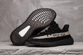 Yeezy 350 V2 Sneakers in Black and Cream - product image from the listing.