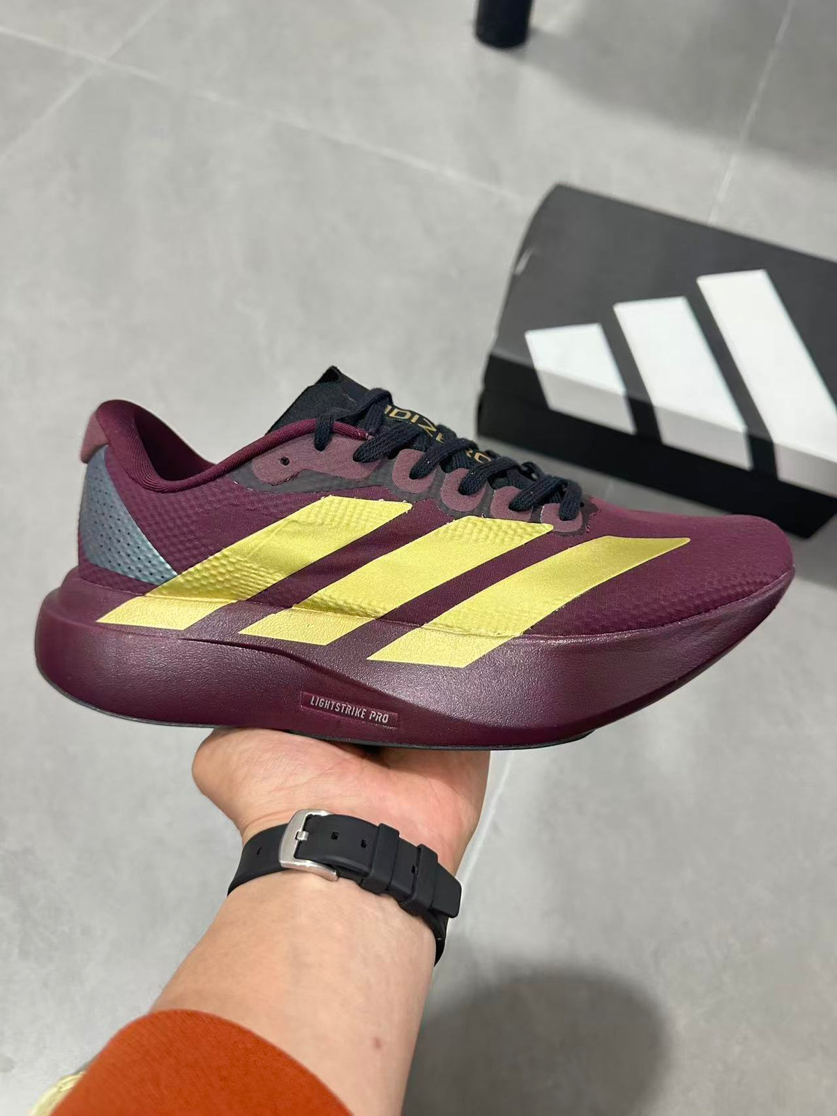 Adidas Lightstrike Pro Running Shoes in Burgundy Gold JQ4443 - product image from the listing.