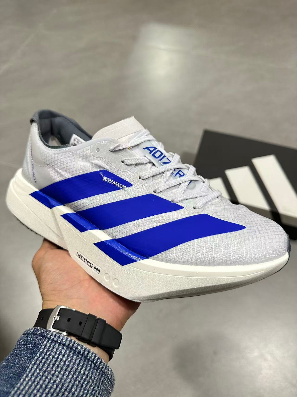 adidas Lightstrike Pro Running Shoes in White Blue - product image from the listing.