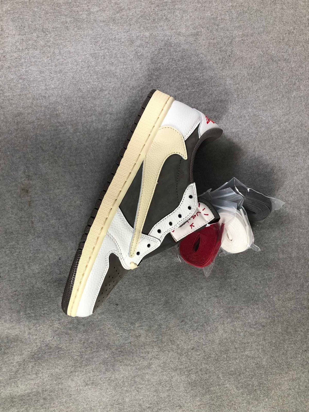 Travis Scott x Air Jordan 1 Low Sneakers in White Brown - product image from the listing.