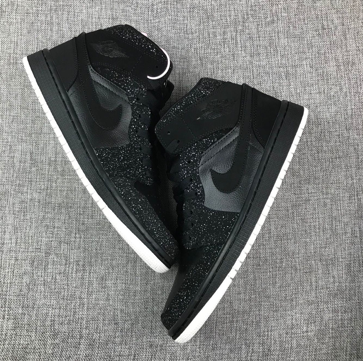 Air Jordan 1 Mid Black and White Sneakers 554724-001 - product image from the listing.