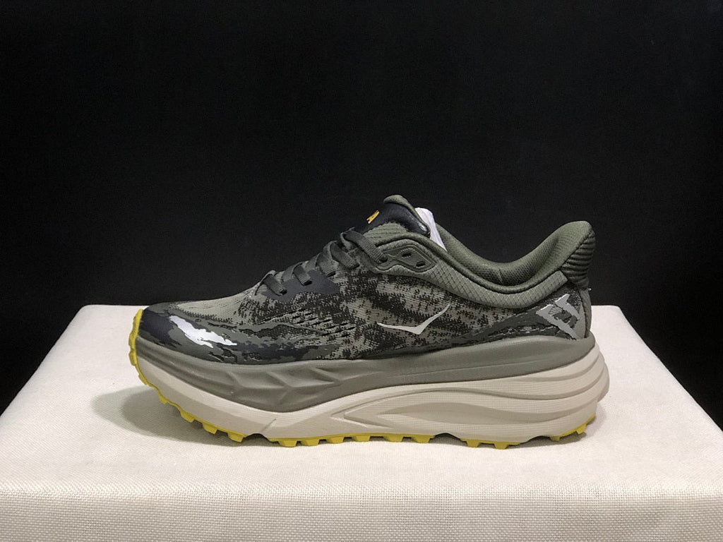 HOKA Stinson 7 Trail Running Shoes, in Gray and Yellow - product image from the listing.