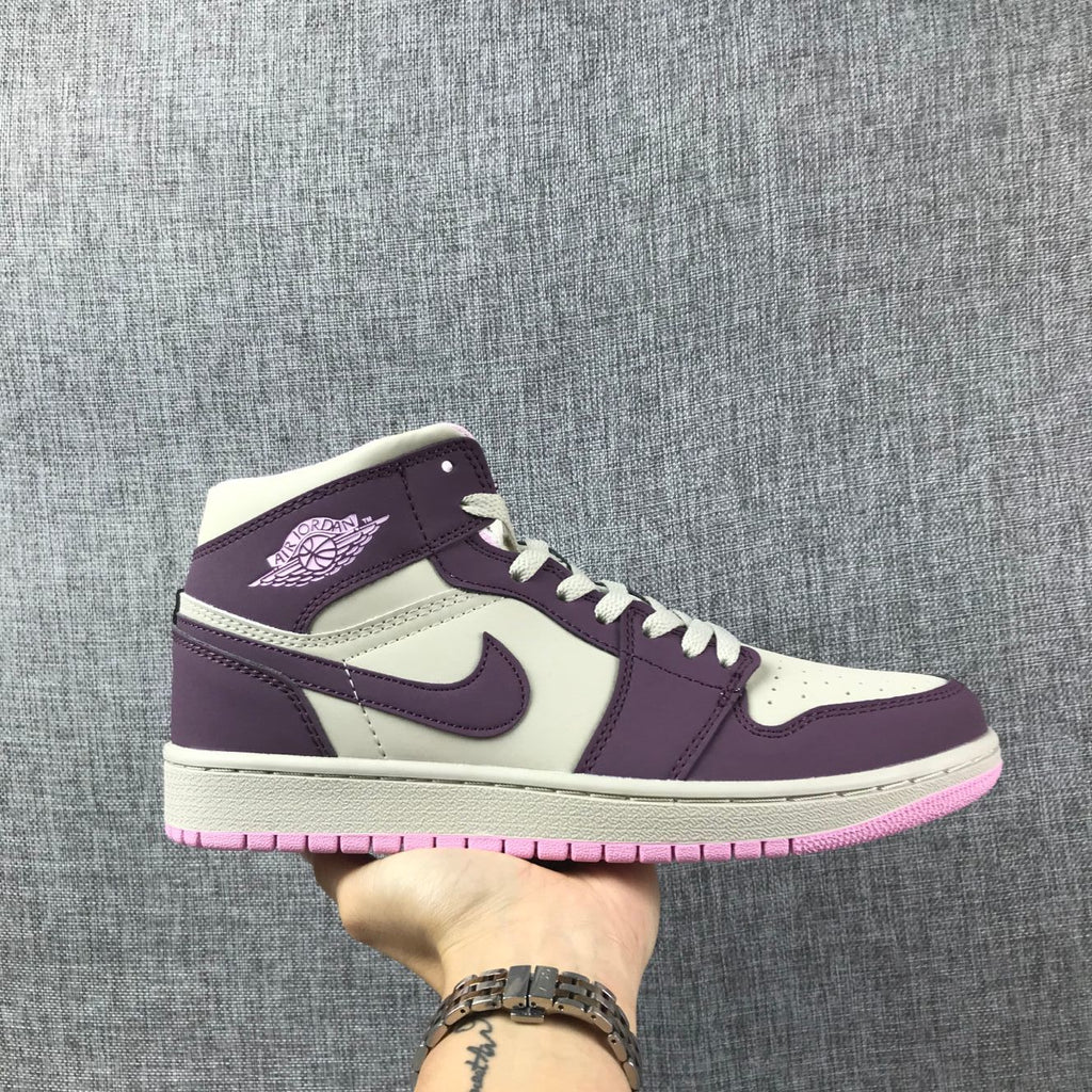 Air Jordan 1 Mid Sneakers in Pink Purple 555112-500 - product image from the listing.