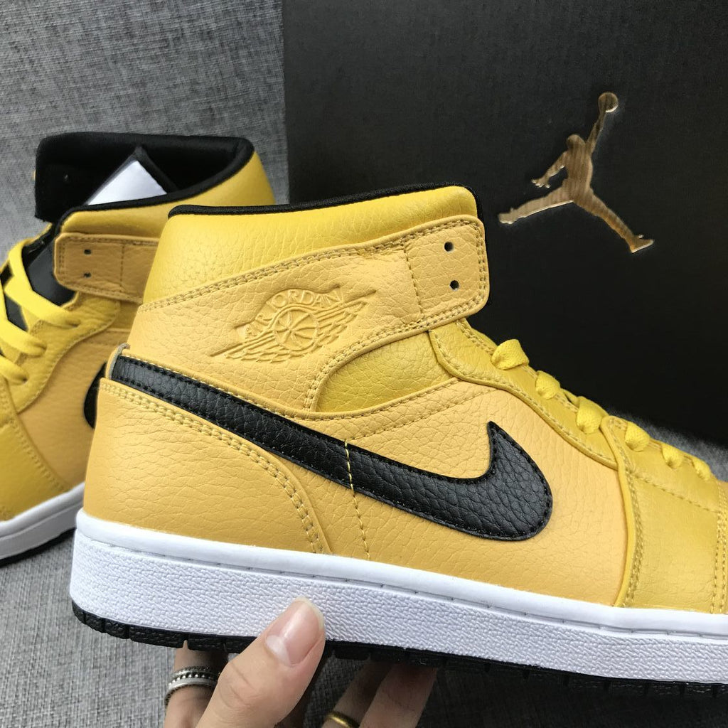Air Jordan 1 Mid Yellow Ochre Sneakers in Black 554724-700 - product image from the listing.