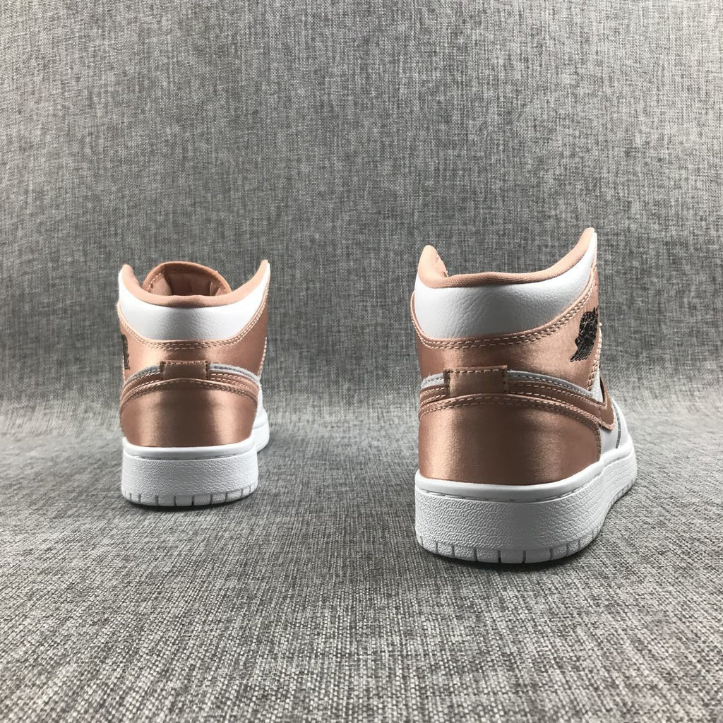 Women's Jordan 1 Mid Rose Gold Silk Sneakers 555112-190 - product image from the listing.