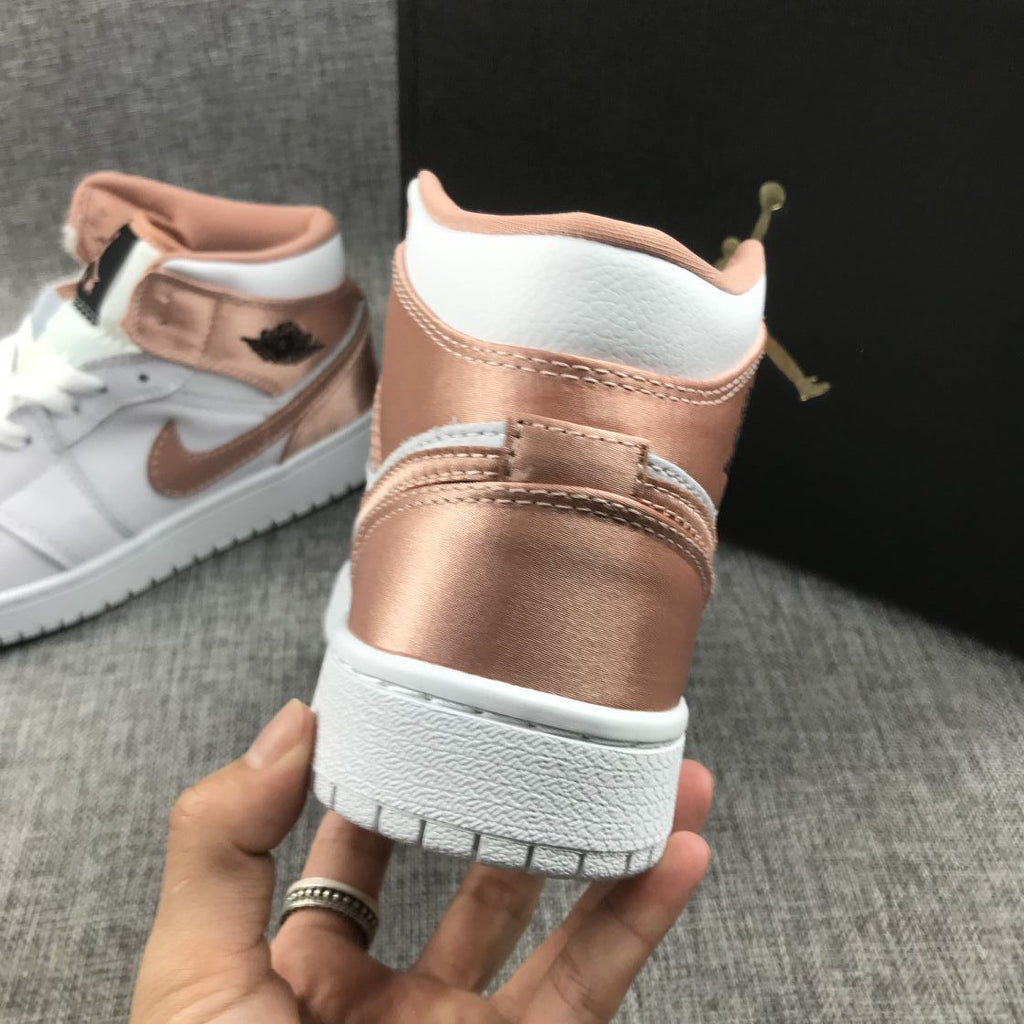 Women's Jordan 1 Mid Rose Gold Silk Sneakers 555112-190 - product image from the listing.