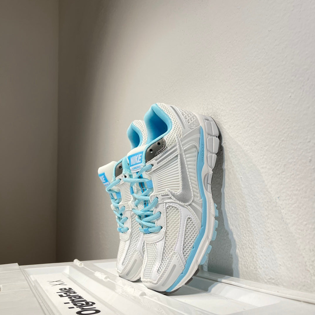 Nike Air Zoom Vomero 5 Sneakers in White and Blue - product image from the listing.