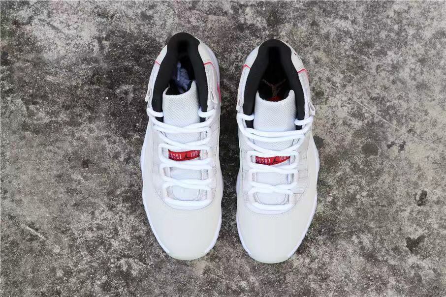 Air Jordan 11 Platinum Tint White High-Top Sneakers - product image from the listing.