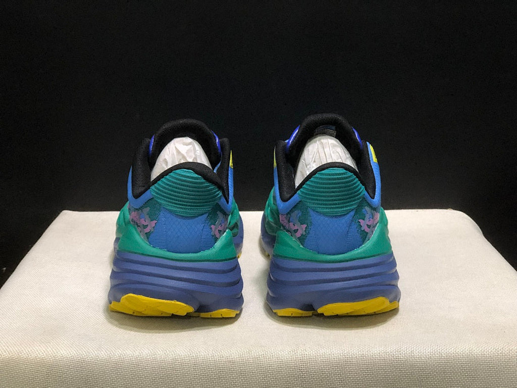 HOKA Stinson 7 Trail Sneakers in Blue Green Pink Yellow - product image from the listing.