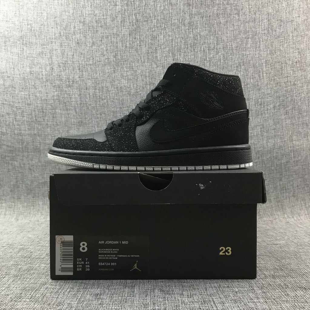 Air Jordan 1 Mid Black and White Sneakers 554724-001 - product image from the listing.
