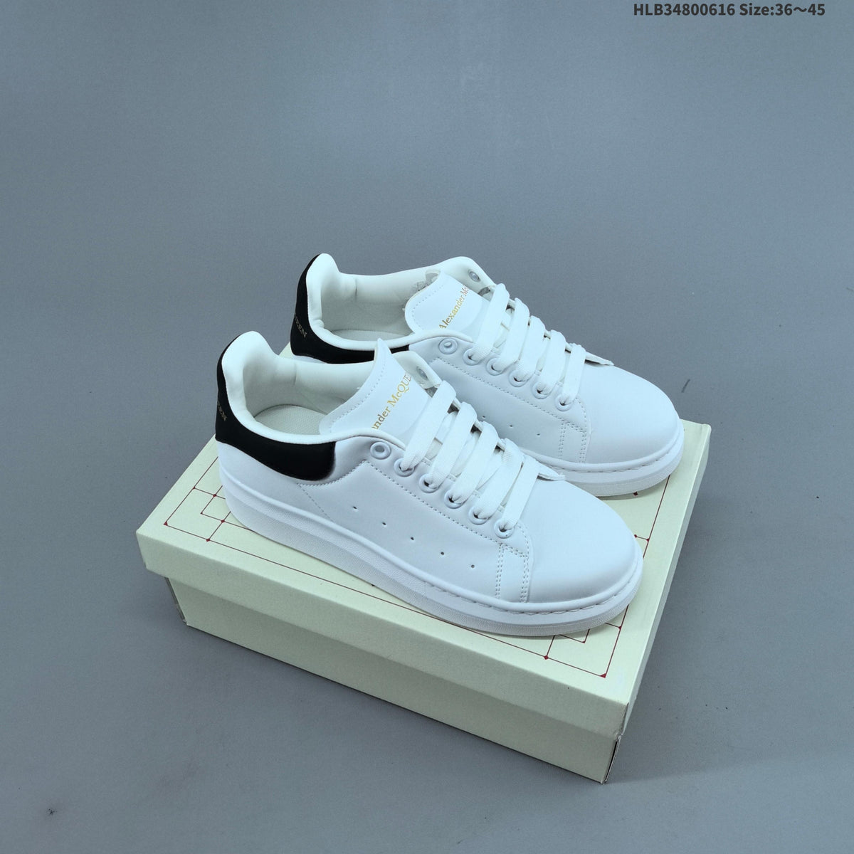 Alexander McQueen Oversized Low-Top Sneakers, in White and Black - product image from the listing.