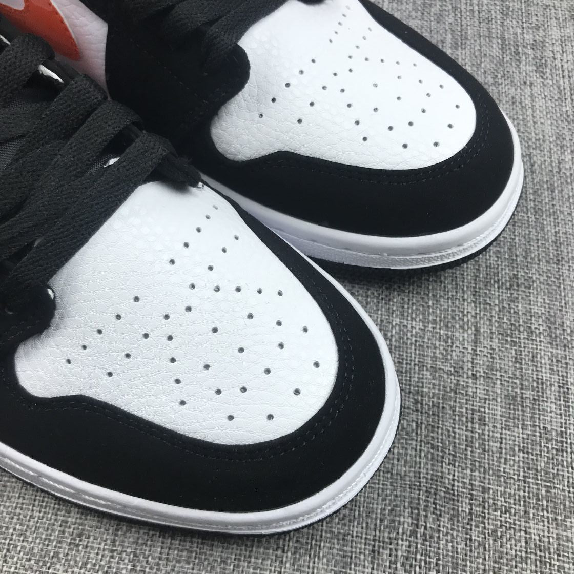Air Jordan 1 Mid Sneakers in Black White Orange 554724-058 - product image from the listing.