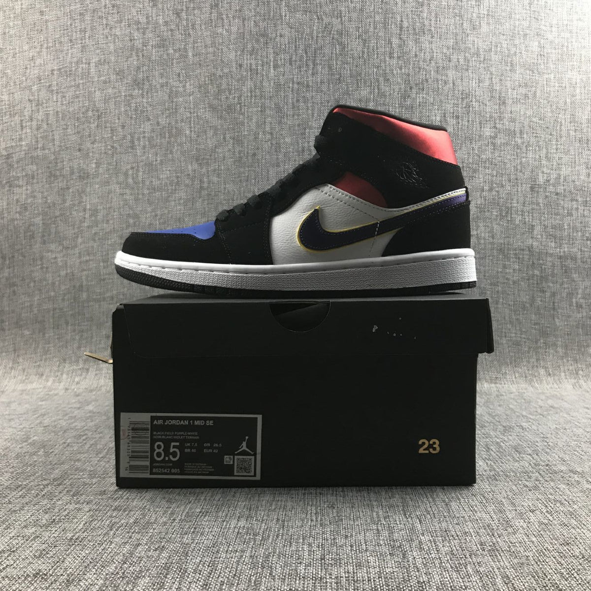 Air Jordan 1 Mid SE Sneakers in Black Purple Yellow 852542-005 - product image from the listing.
