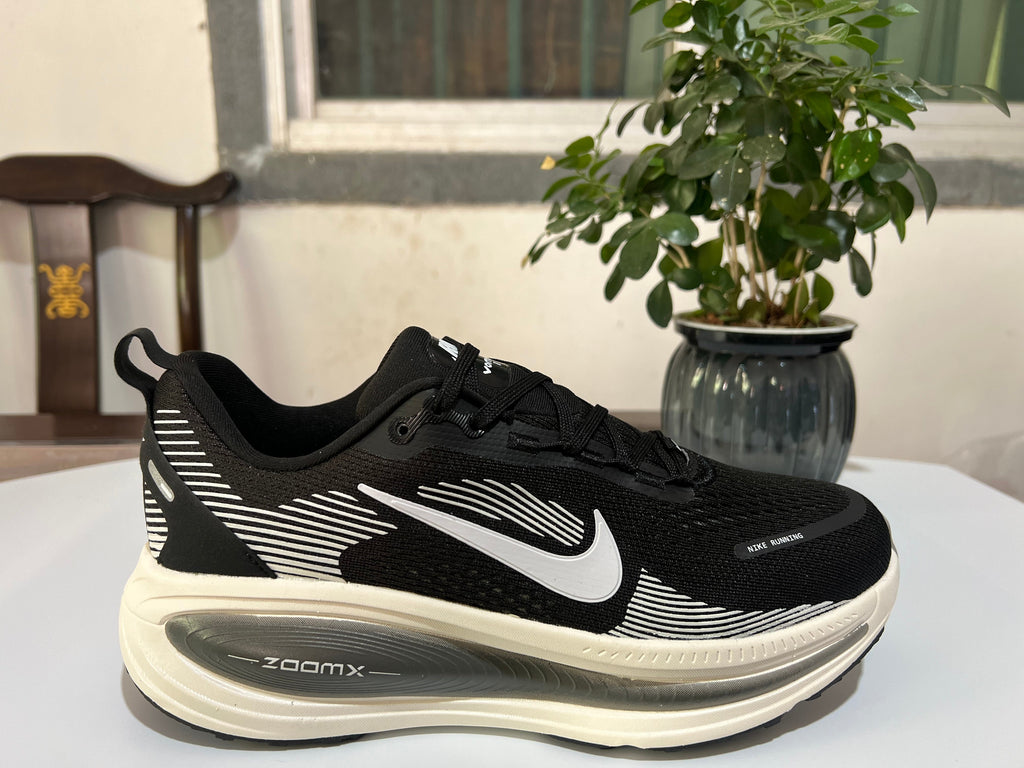 Nike Vomero 18 Running Shoes in Black and White - product image from the listing.