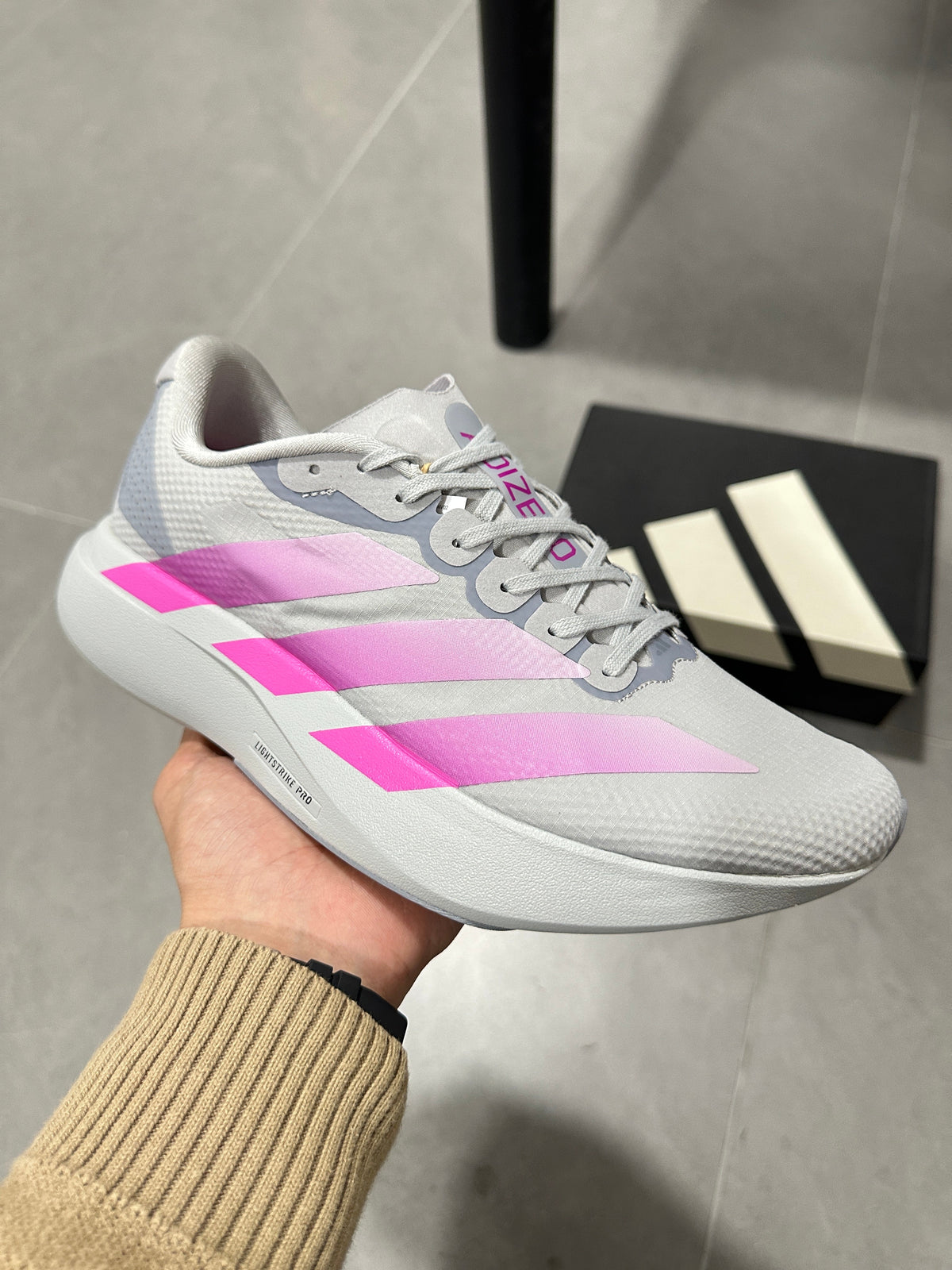 adidas Adizero Lightstrike Pro Running Shoes, in Gray and Pink - product image from the listing.