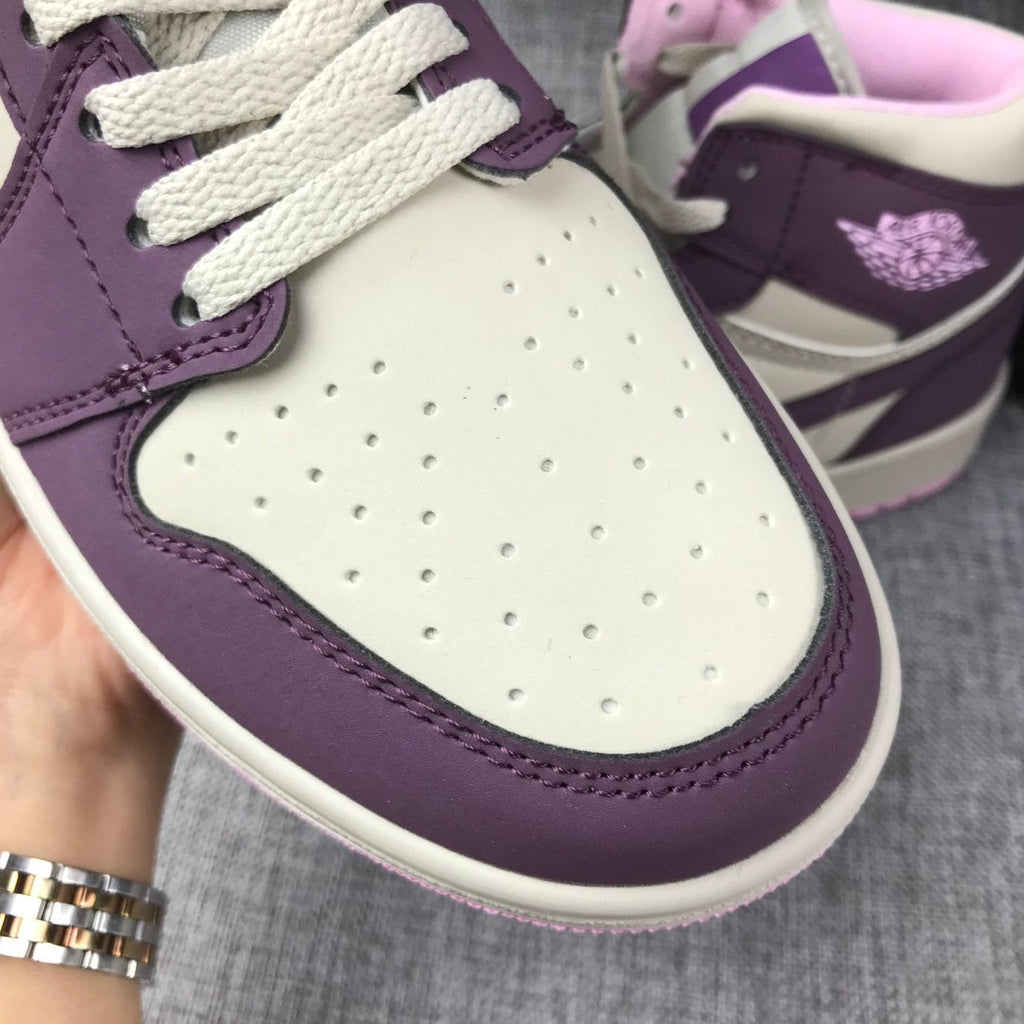 Air Jordan 1 Mid Sneakers in Pink Purple 555112-500 - product image from the listing.
