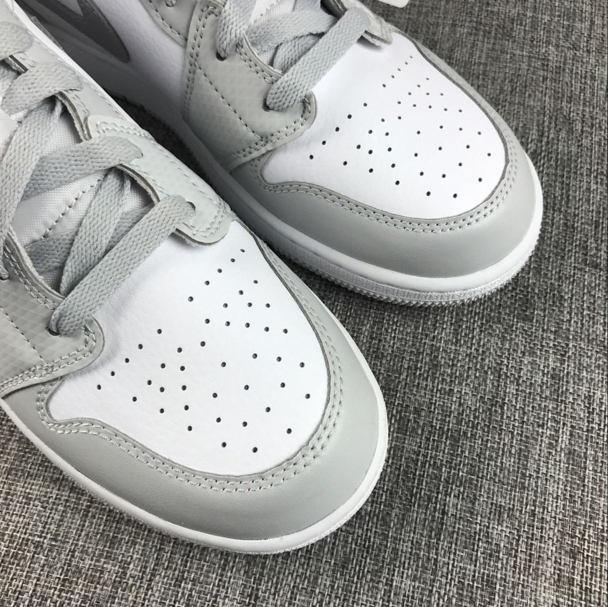 Air Jordan 1 Mid GS White and Silver Sneakers - product image from the listing.