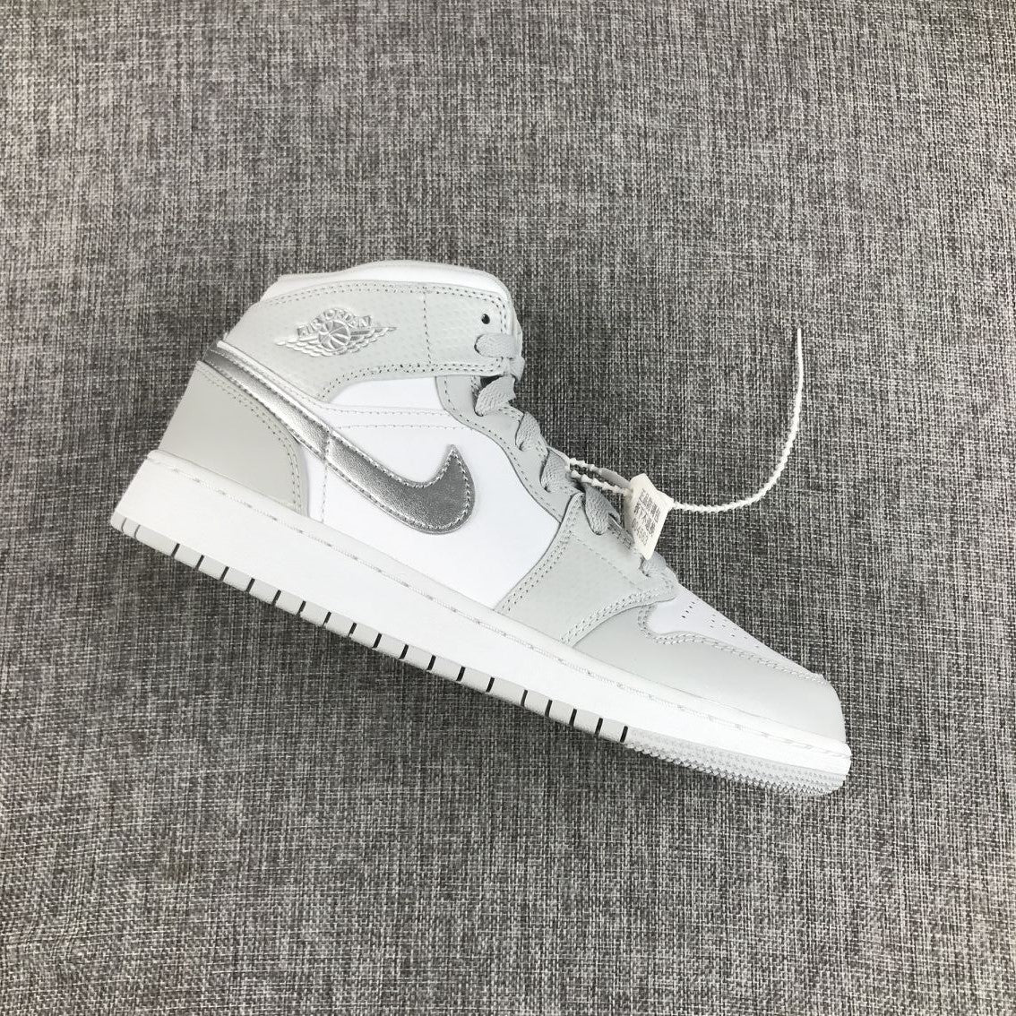 Air Jordan 1 Mid GS White and Silver Sneakers - product image from the listing.