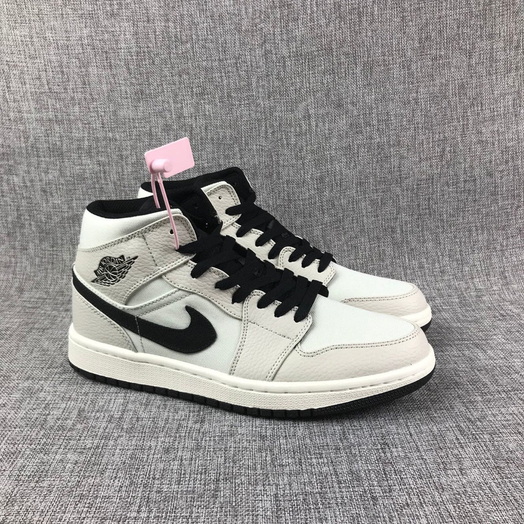 Air Jordan 1 Mid High-Top Sneakers in Grey and Black - product image from the listing.