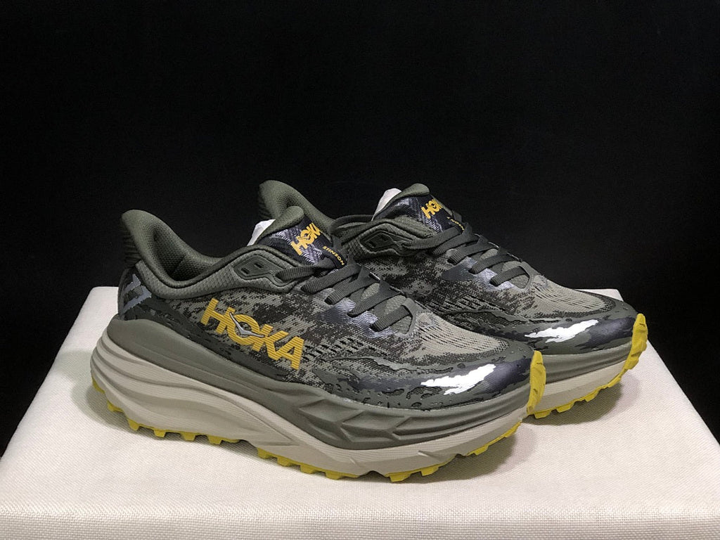HOKA Stinson 7 Trail Running Shoes, in Gray and Yellow - product image from the listing.