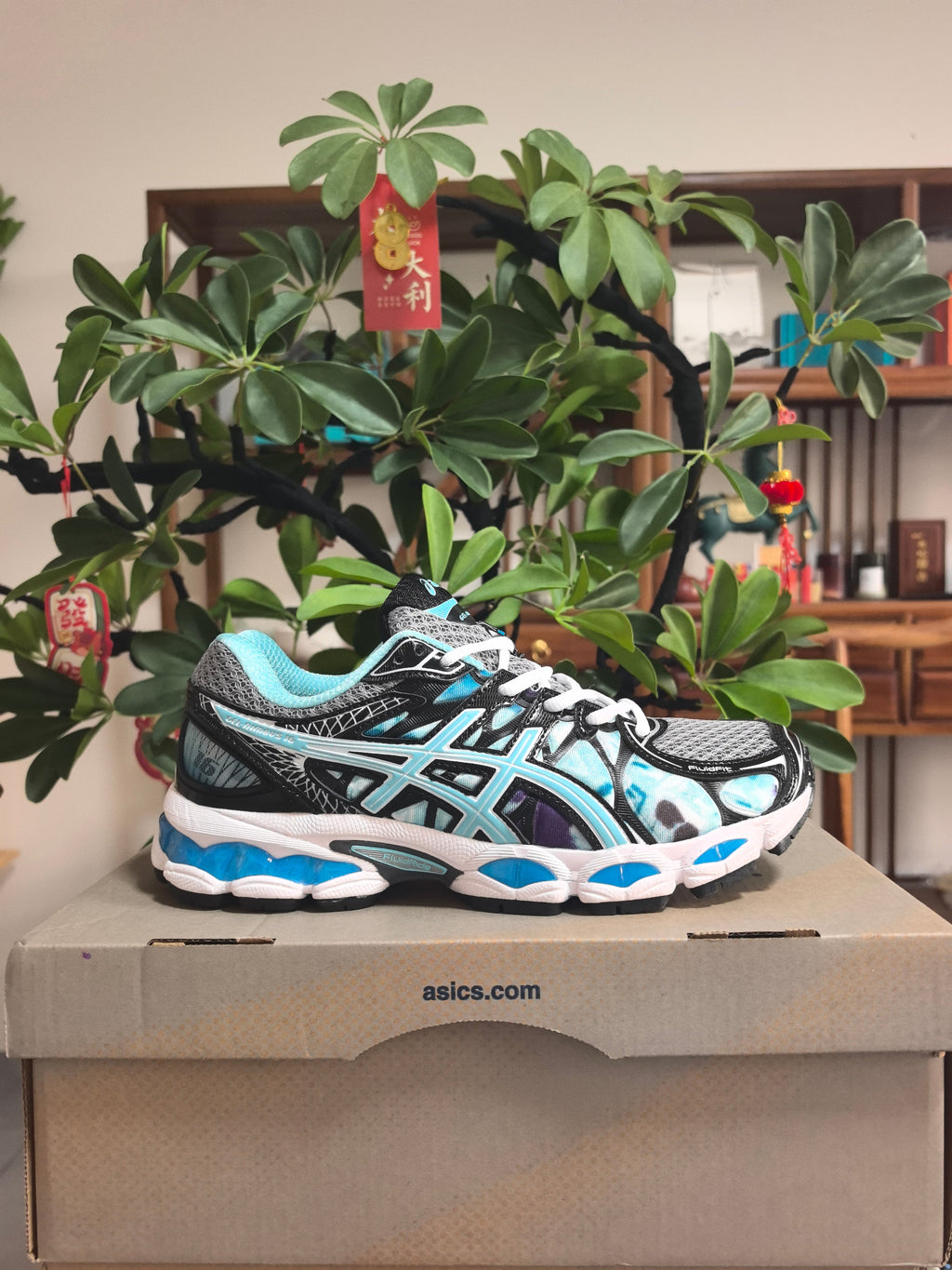 ASICS GEL-NIMBUS 16 Sneakers in Black, in Gray and Ice Blue - product image from the listing.