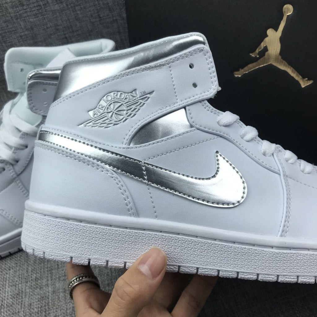 Air Jordan 1 Mid Sneakers in White Silver 554724-105 - product image from the listing.