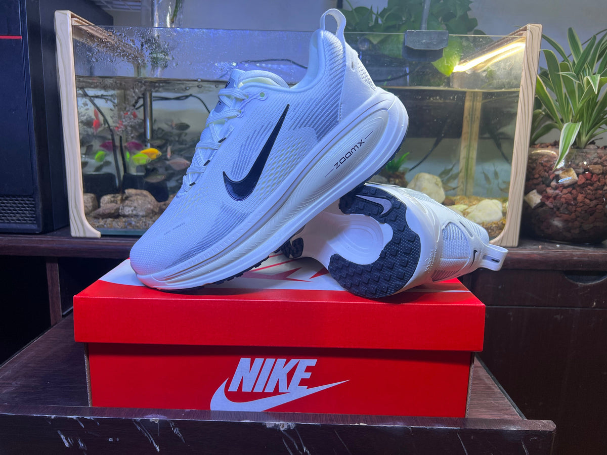 Nike Vomero 18 Running Shoes in Blue and White - product image from the listing.