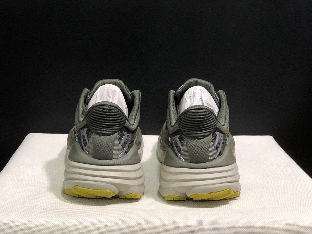 HOKA Stinson 7 Trail Running Shoes, in Gray and Yellow - product image from the listing.