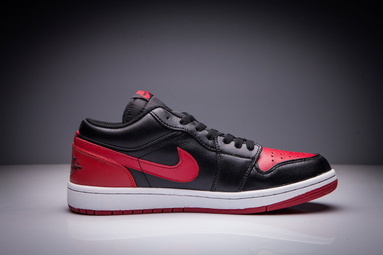 Jordan 1 Low Sneakers in Black and Red - product image from the listing.