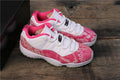 Women's Air Jordan 11 Retro Low Pink Snakeskin Sneakers - product image from the listing.