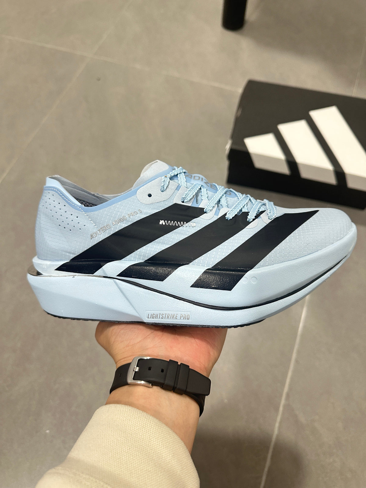 adidas Adizero Adios Pro Running Shoes, in Light Blue and Black - product image from the listing.
