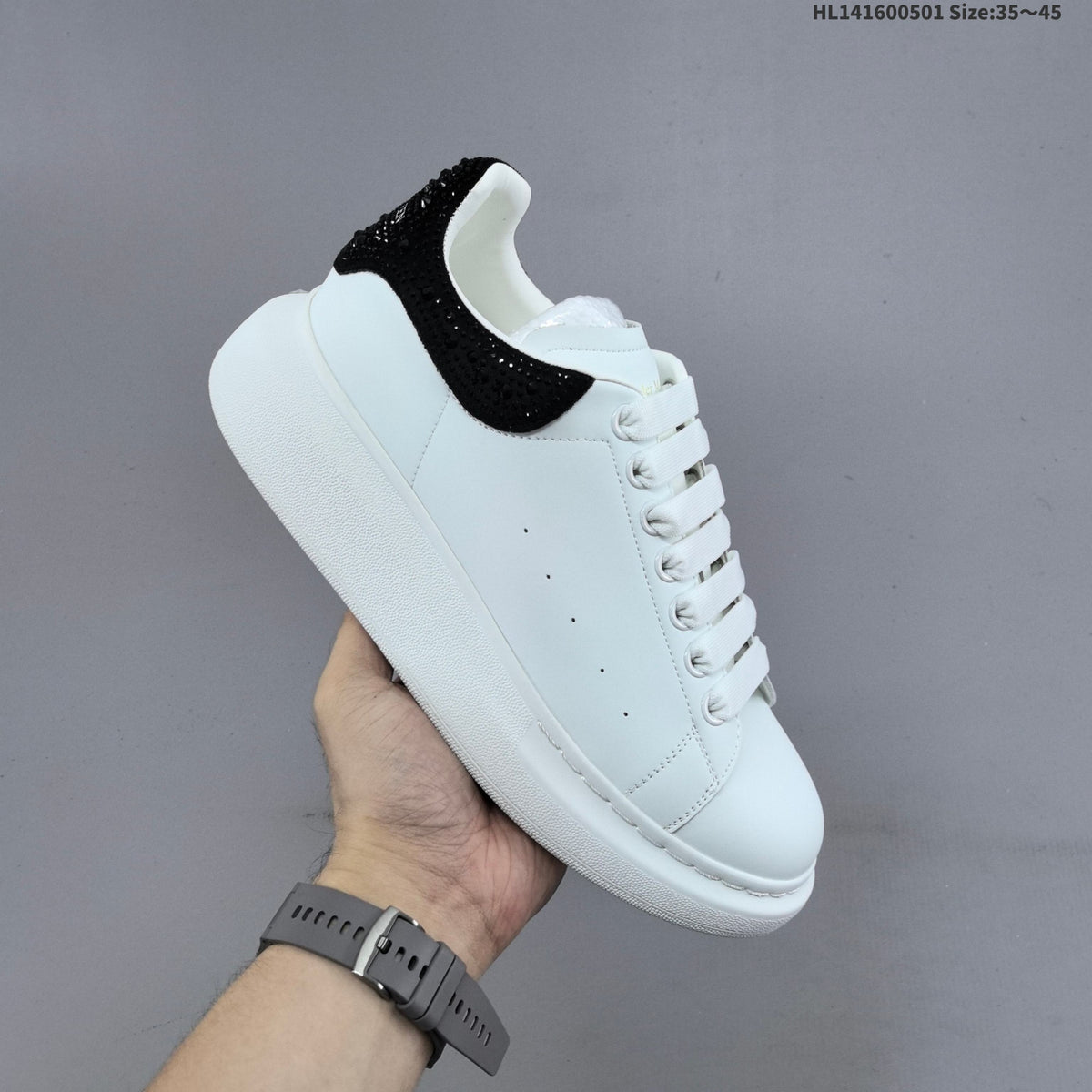 Alexander McQueen Oversized White Low-Cut Sneakers with Black Heel - product image from the listing.