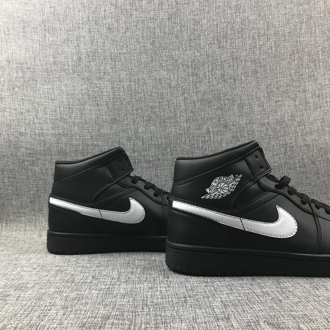 Air Jordan 1 Mid Sneakers in Black White 554724-049 - product image from the listing.