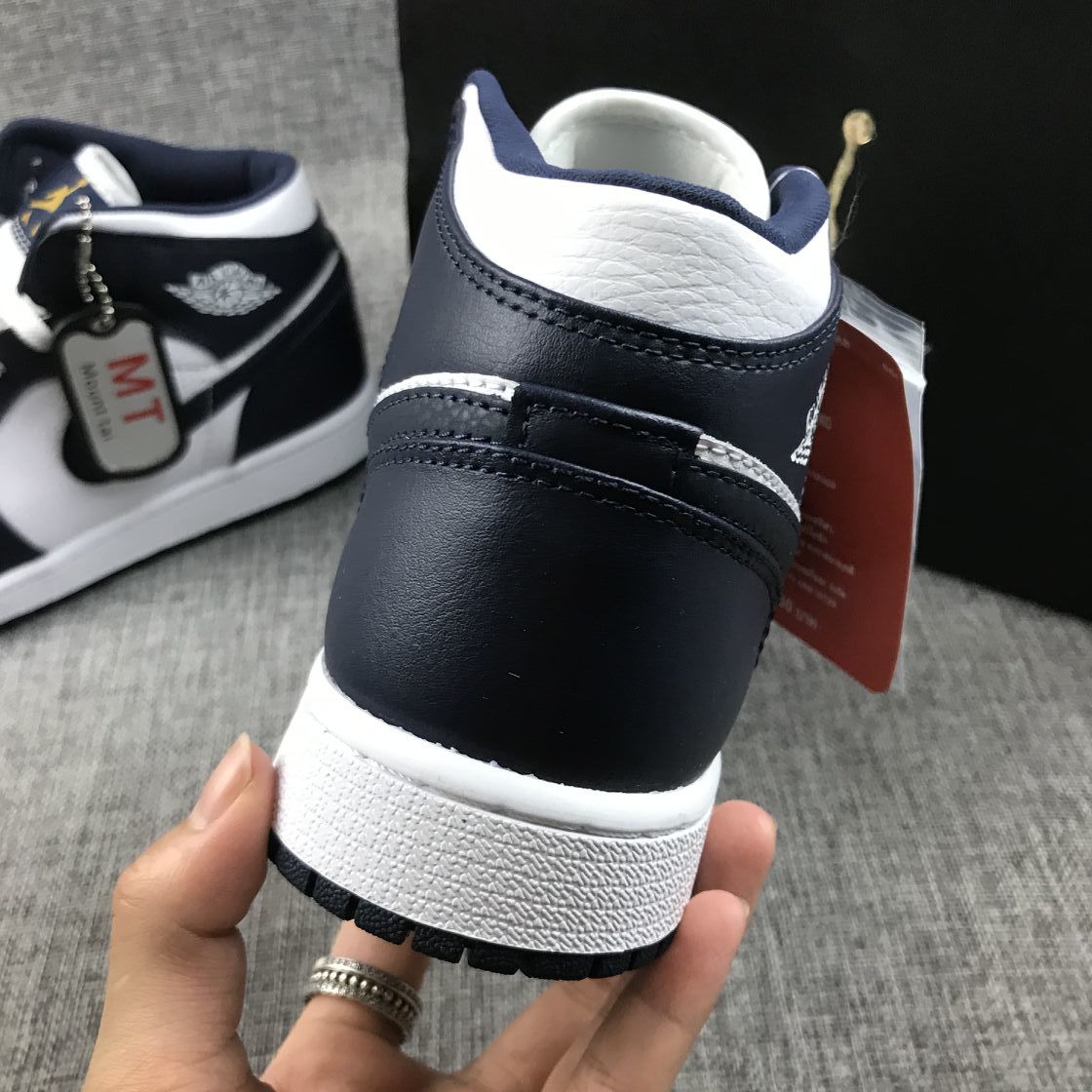 What The Obsidian Sneakers - Jordan 1 Mid 554724-174 - product image from the listing.