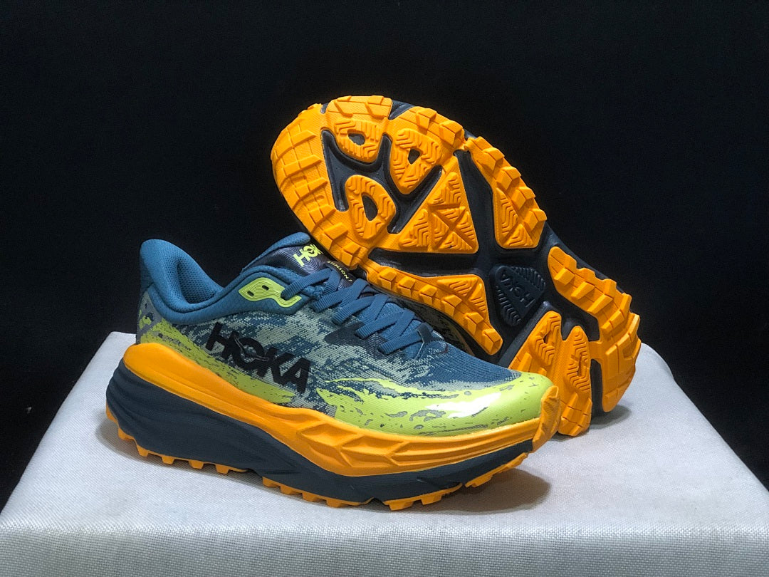 HOKA Stinson 7 Trail Running Shoes in Blue Yellow Orange - product image from the listing.