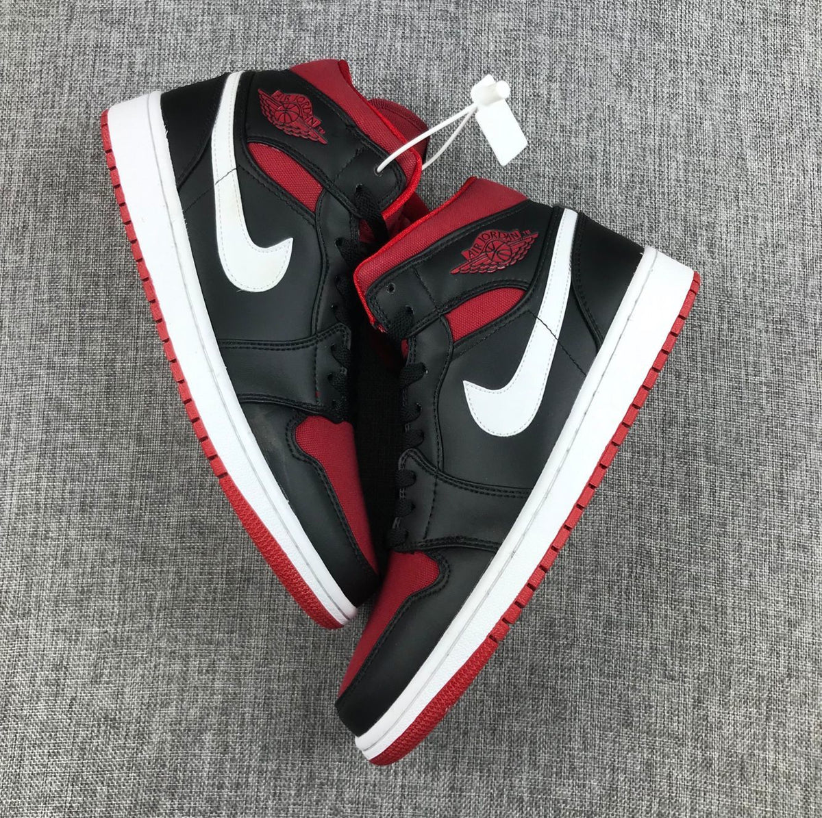 Black Red Canvas-Style Sneakers - Jordan 1 Mid 554724-020 - product image from the listing.