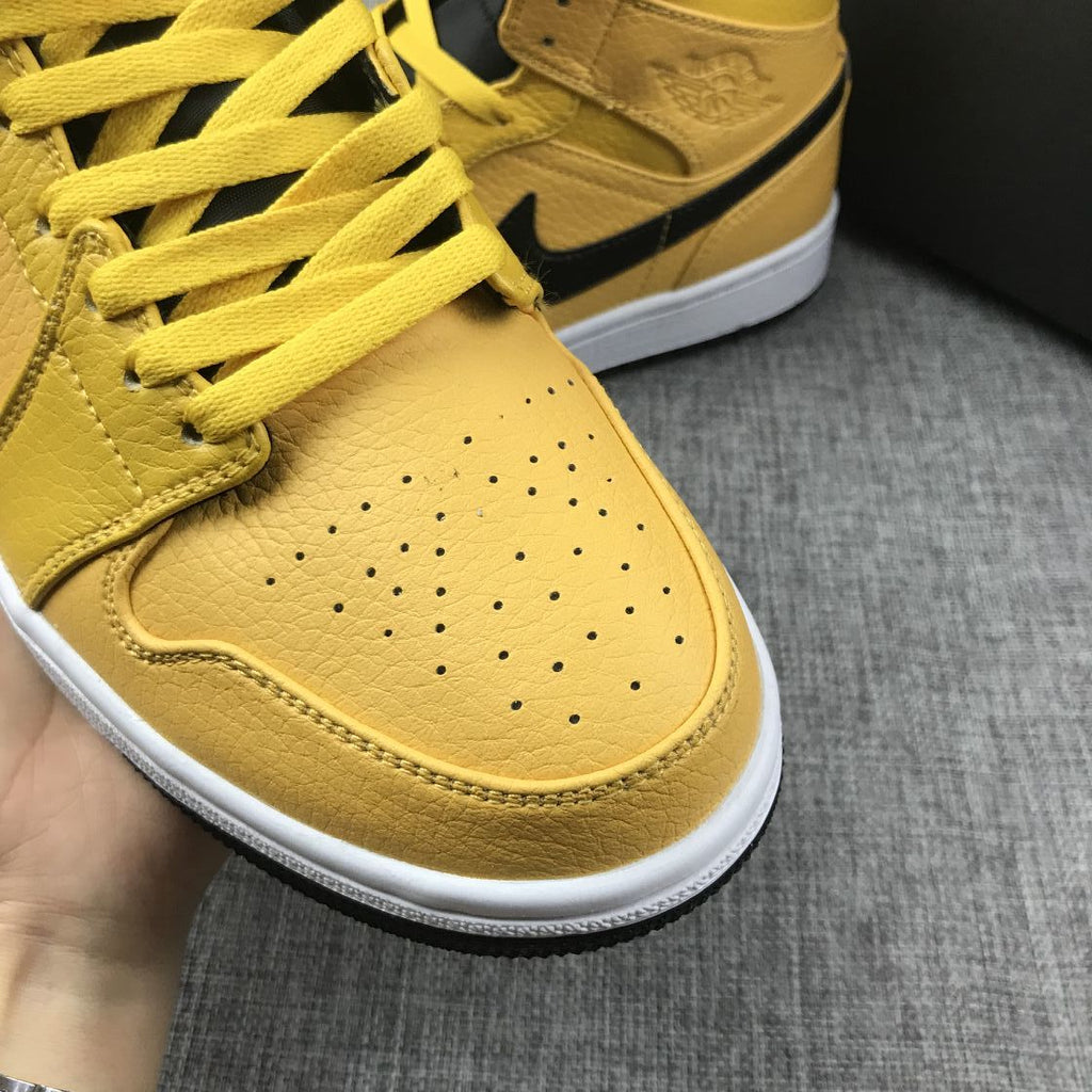 Air Jordan 1 Mid Yellow Ochre Sneakers in Black 554724-700 - product image from the listing.