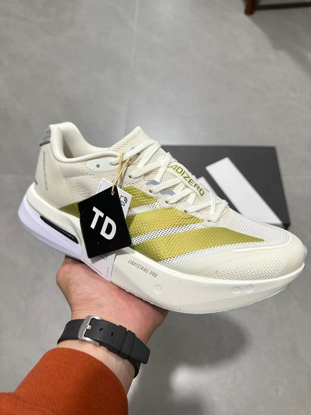 Adizero Lightstrike Pro Running Shoes in White and Olive JS4947 - product image from the listing.