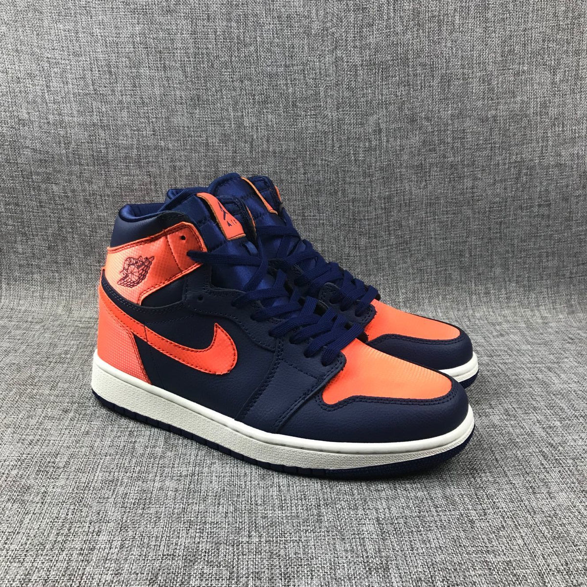 Air Jordan 1 Mid Sneakers in Blue Orange AH7389-408 - product image from the listing.