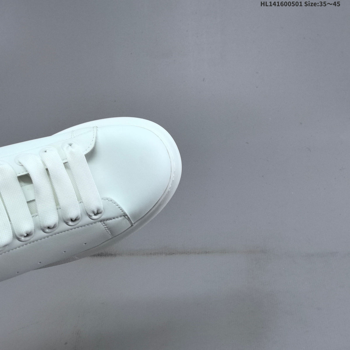 Alexander McQueen Oversized White Low-Cut Sneakers with Black Heel - product image from the listing.
