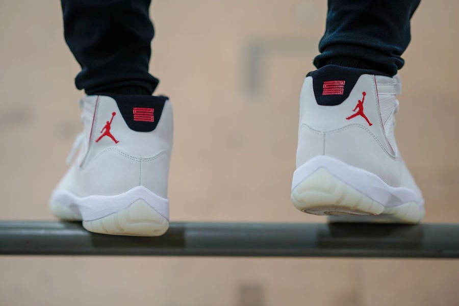 Air Jordan 11 Platinum Tint White High-Top Sneakers - product image from the listing.