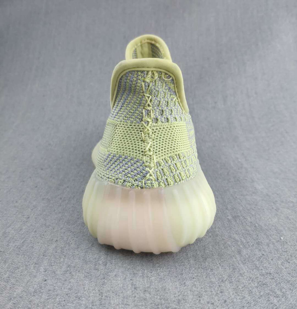 Pale Yellow and Gray Yeezy 350 V2 Knit Sneakers - product image from the listing.
