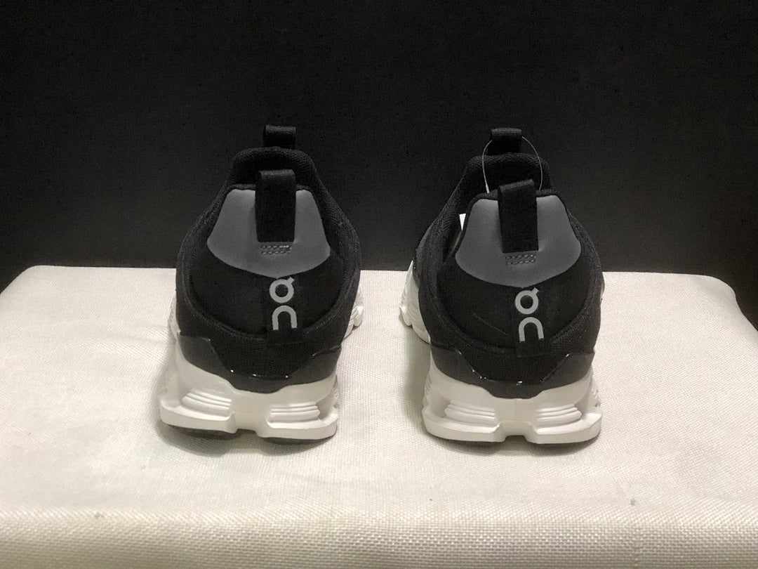 On Cloud X 4 Coast Sneakers in Black and White - product image from the listing.